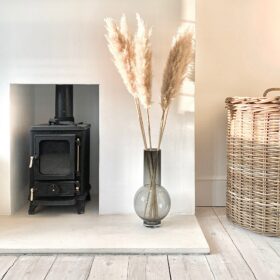 Hobbit small wood burning stove installed in a small fireplace - hotboxstoves.co.uk