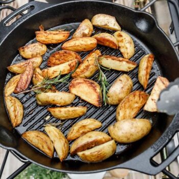 Petromax cast iron grill skillet with two handles lifestyle image - hotboxstoves.co.uk