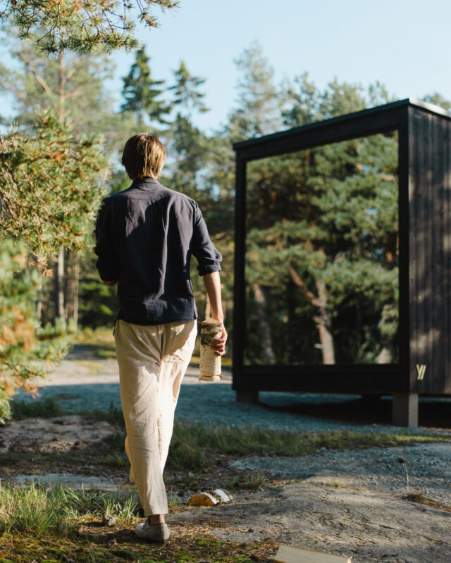 Tyyni 10 a man walking towards the sauna - hotboxstoves.co.uk